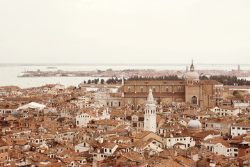 Fototapeta premium Venice roofs from above. Aerial view of houses, sea and palaces from San Marco tower