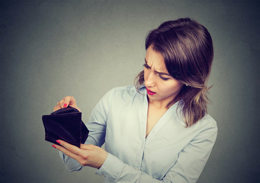 Woman with no money. Businesswoman holding empty wallet