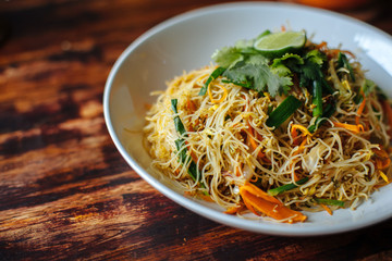 Healthy Vegetarian vegan menu Delicious Singapore style Stir fried rice noodles with carrot orange...