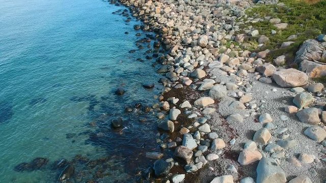 Aerial drone shot of a rocky ocean coast line on the west coast of Sweden in Halland outside of Gothenburg.