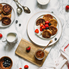 Gluten free, vegetarian breakfast. Pancakes made from tofu with strawberries, maple syrup and oatmeal. The concept of a vegan good breakfast