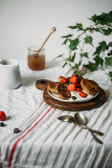 Gluten free, vegetarian breakfast. Pancakes made from tofu with strawberries, maple syrup and oatmeal. The concept of a vegan good breakfast
