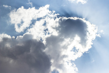Sun on blue sky with clouds 