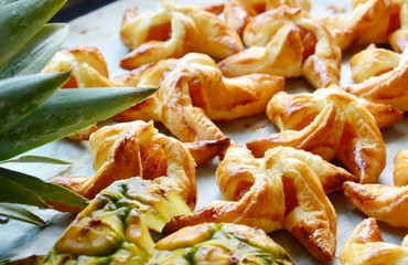 a lot of homemade Pineapple pie  wind turbine shaped.
puff pastry Pineapple pin wheels.