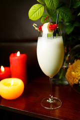 Milkshake with berries on wooden table