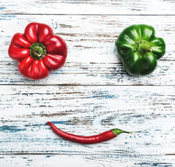 A smile of red and green peppers. Composition of fresh vegetables, top view