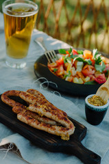 Grilled sausages with spices and beer