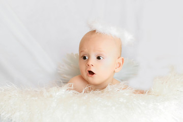 portrait of a funny boy angel for 5 months isolated on a white background. copyspace for your text