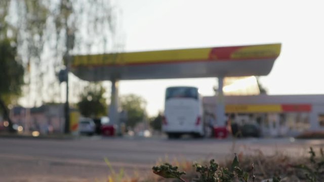 Timelapse of traffic at a gas station, blurred, defocused