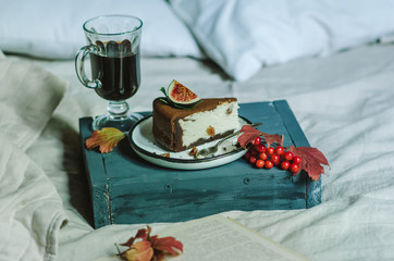 Breakfast in bed with with coffee and chocolate cheesecake