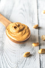 Wooden spoon of peanut butter