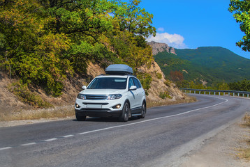 Obraz na płótnie Canvas SUV on road in mountain district