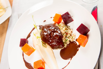 Beef cheeks with vegetables, roasted parsley root mousse , pearl barley, dark chocolate and demi glace sauce