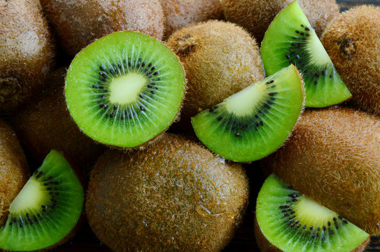 A lot of fresh Kiwi fruits  on wooden floor.
Kiwis are a nutrient dense food, they are high in nutrients and low in calories.