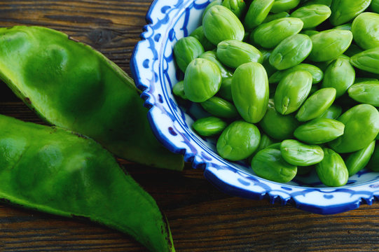 Parkia speciosa or English name is bitter bean, twisted cluster bean or stink bean and Thai name is sataw or sator  on wooden background.