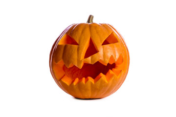 Orange pumpkin carved into creepy and funny Jack o Lantern isolated on white background. All hallows night. Copy space, close up, top view. Halloween party decoration. Trick or treat concept.