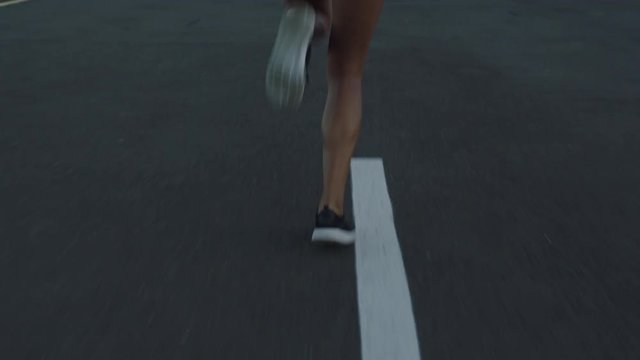 woman runner legs running on city street at sunrise jogging exercising fit female athlete training