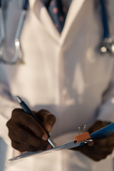 Handsome guy doctor in white lab coat with stethoscope on white background