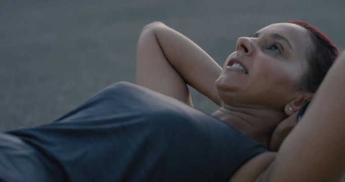 overweight indian woman runner training sit ups exercise in city enjoying intense cardio workout at sunrise close up
