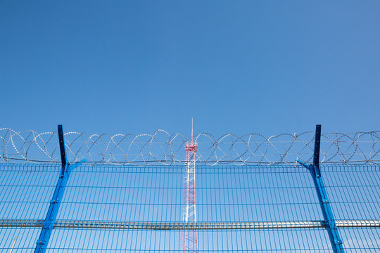Area with barbed wire. Dangerous area. Private territory. Energy tower