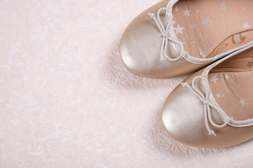 Kids shoes of gold colour.Moccasins for little princess