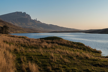 Obraz premium Landscape view of Old Man of Storr rock formation and lake, Scotland, United Kingdom