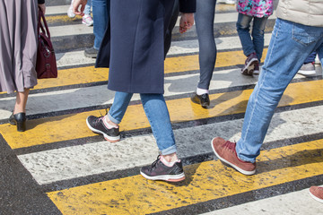 people passing on the road at a pedestrian crossing.
