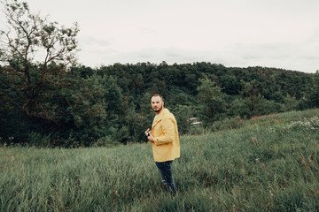 a man in a yellow raincoat with a camera