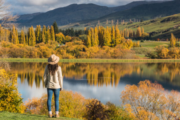 Fototapeta na wymiar Woman staring lake wakatipu, Queenstown, New Zealand