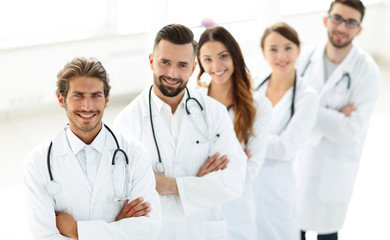 Fototapeta premium Portrait of medical team standing with arms crossed in hospital