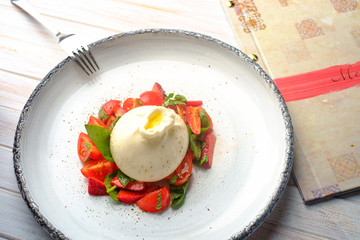burrata cheese with strawberries in plate