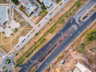 Aerial top view of asphalt road street with cars traffic in city, urban transportation concept