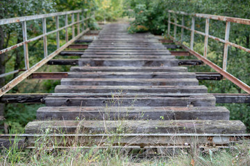 Old unused railway bridge. A small railway crossing over the river in central europe.