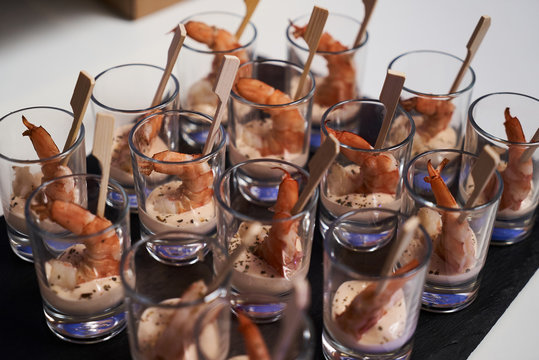 Shrimp Cocktail With Sauce On Black Stone Tray Table. Glasses With Seafood Snacks, Close-up. Smorgasbord  Food Concept 