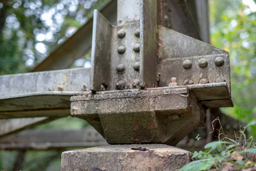 The old truss of the railway bridge. Steel construction connected by rivets.