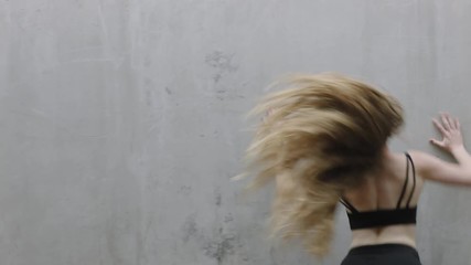 dancing woman beautiful young caucasian street dancer performing contemporary moves enjoying modern dance expression practicing in grungy warehouse close up