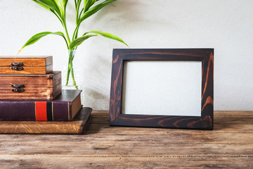 Wood frame photo old vintage put on grunge wooden table desk design.