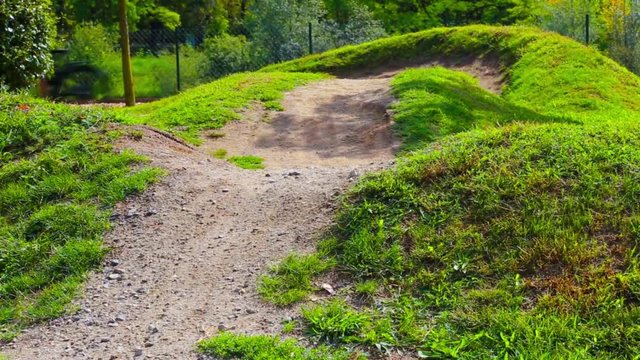 Man is riding his mountain bike in a bike parcours