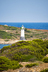Fototapeta na wymiar A beautiful lighthouse during a sunny day in Sardinia, Italy.