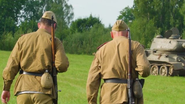 19904_Two_old_military_personel_walking_on_the_grassy_lawn_in_Valga_Estonia.mov