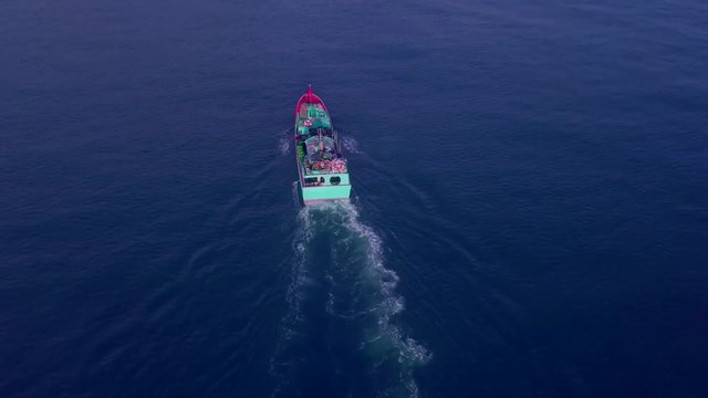 Aerial view indonesia pinisi traditional wooden boat from above passing by benoa bay bali