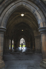 Student walking in the Glasgow University Cloisters