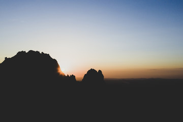 Aerial view of a spectacular sunset behind some rocky mountains in Sardinia, Italy.