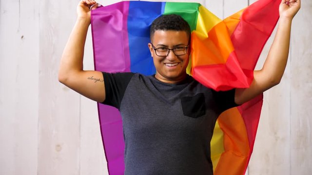 Queer gay black person with pride flag