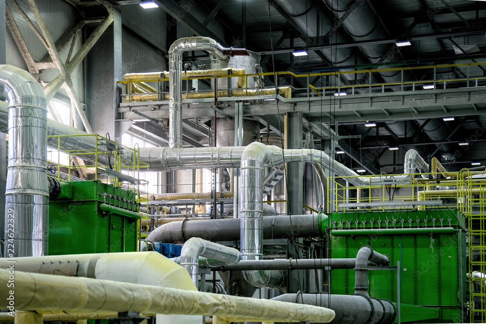 Wall mural Inside modern Chemical factory production line. Industrial equipment, cables, vats and piping