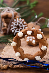 Cookies in the form of a ring with sugar glaze on the background of Christmas decorations.