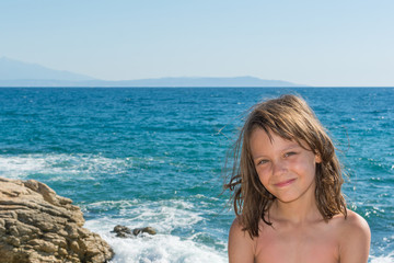 a beautiful girl posing on a beach by the sea
