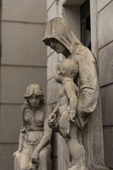 Statue of a mother saying goodbye to her baby