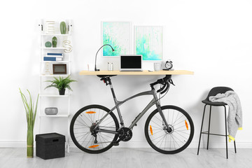 Modern home office interior with bicycle near wall