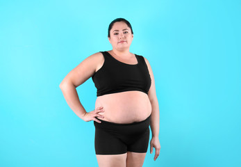 Fototapeta na wymiar Fat woman on color background. Weight loss
